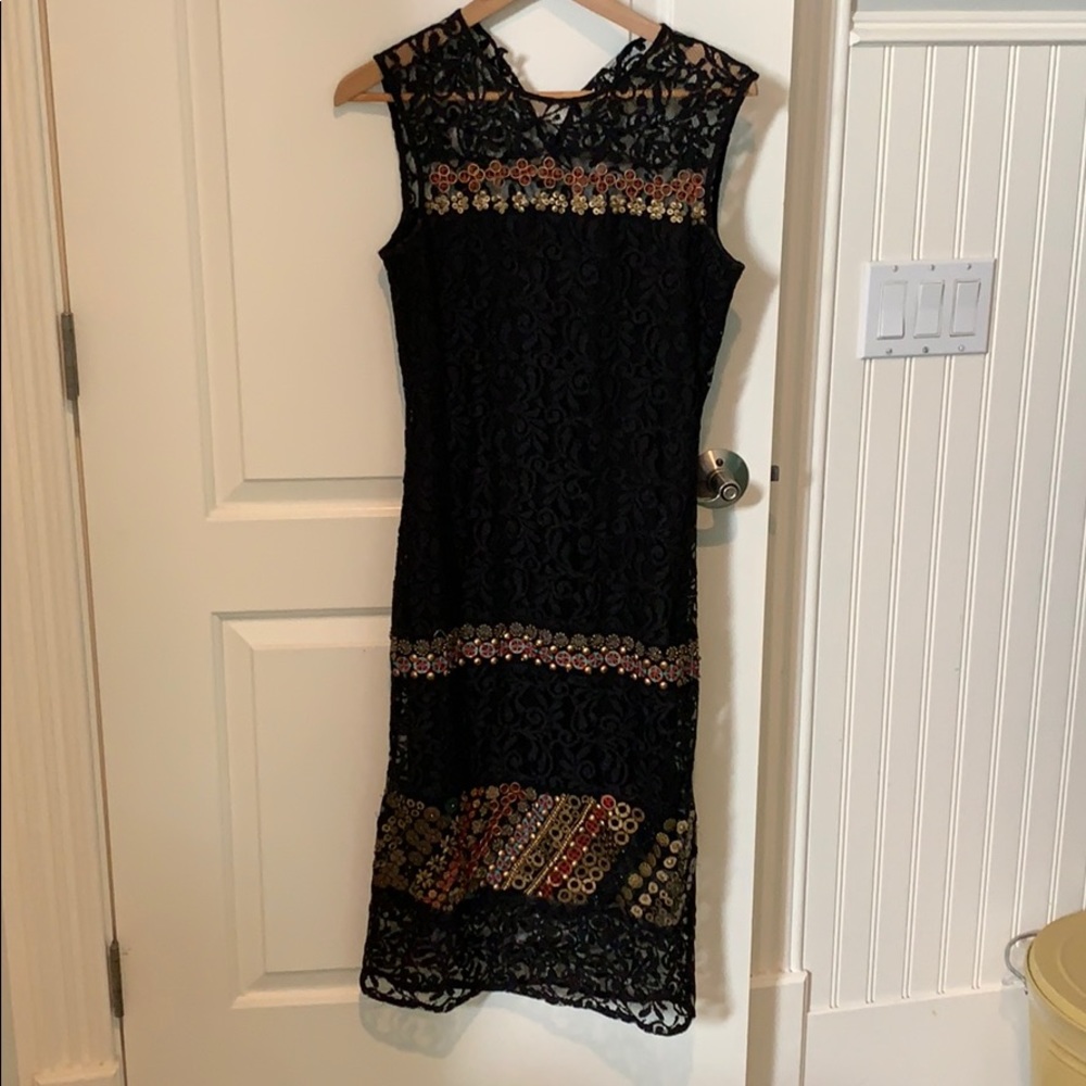 Formal lace dress with red, gold, blue details.